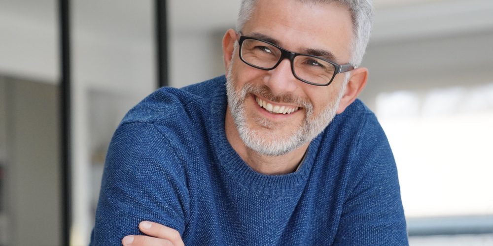 Portrait,Of,Smiling,Man,With,Grey,Hair,And,Glasses dental implants taylorsville