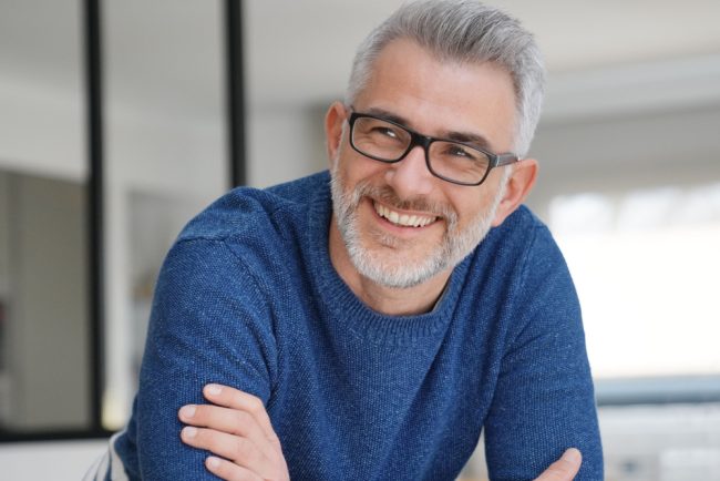 Portrait,Of,Smiling,Man,With,Grey,Hair,And,Glasses dental implants taylorsville