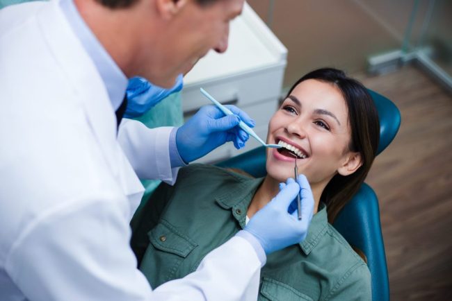 Amazing,Smile!,Top,View,Of,Dentist,Examining,His,Beautiful,Patient dental cleanings taylorsville