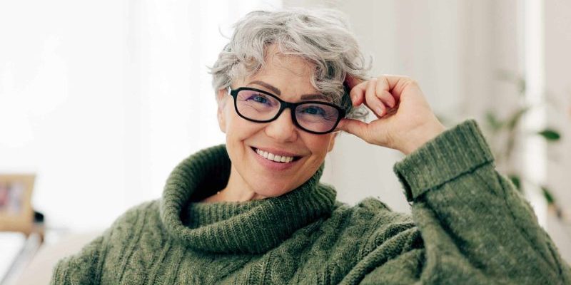 Restore Your Smile With Our Restorative Dentist in Taylorsville — smiling senior woman in glasses